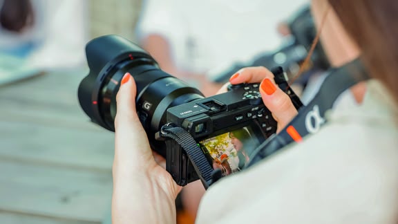 Perspektive einer Fotografin: Kamera in den Händen, von hinten fotografiert